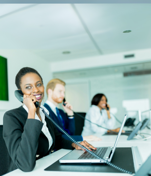 Call center with smiling reps answering calls.