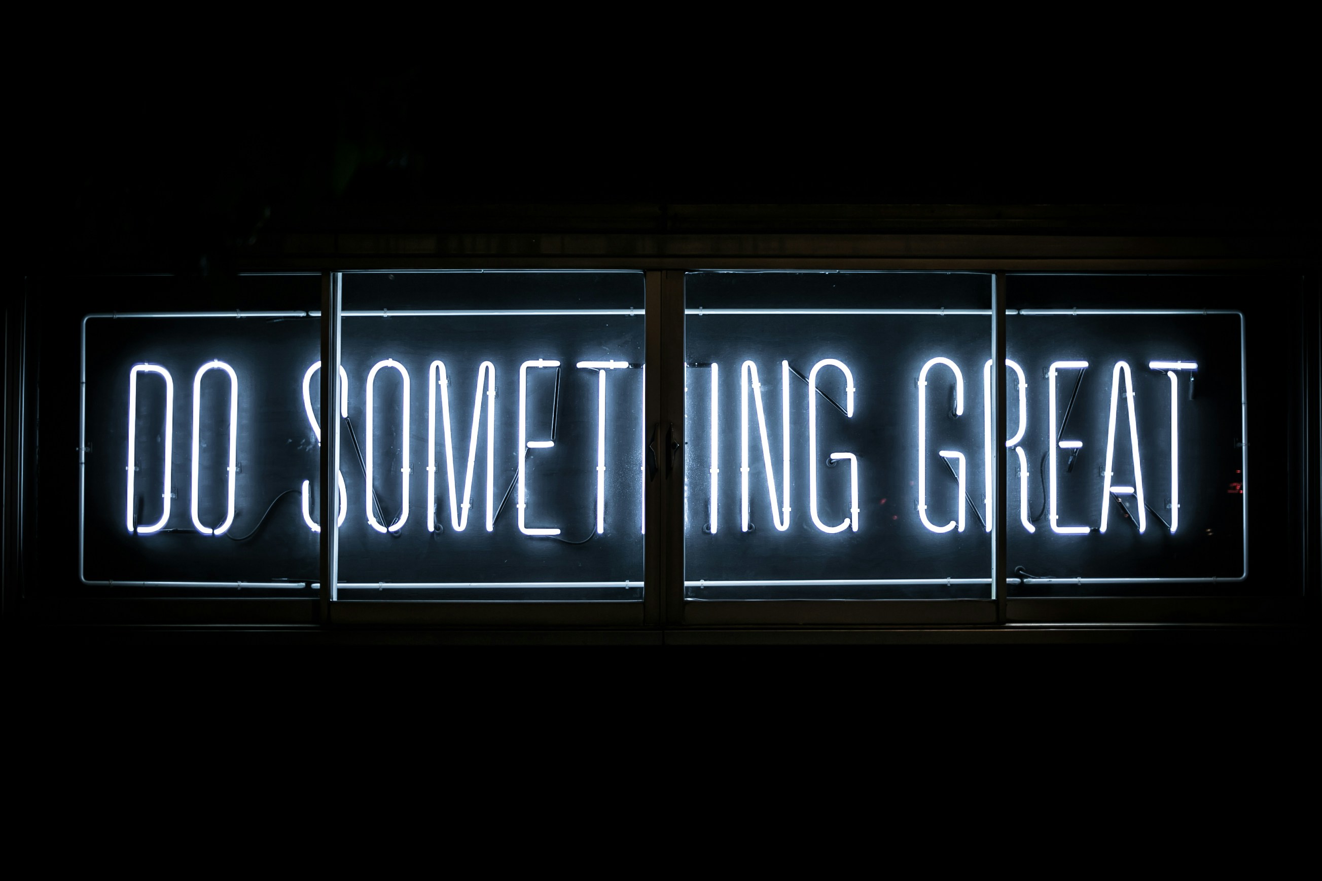 The words, "Do Something Great," in neon letters.