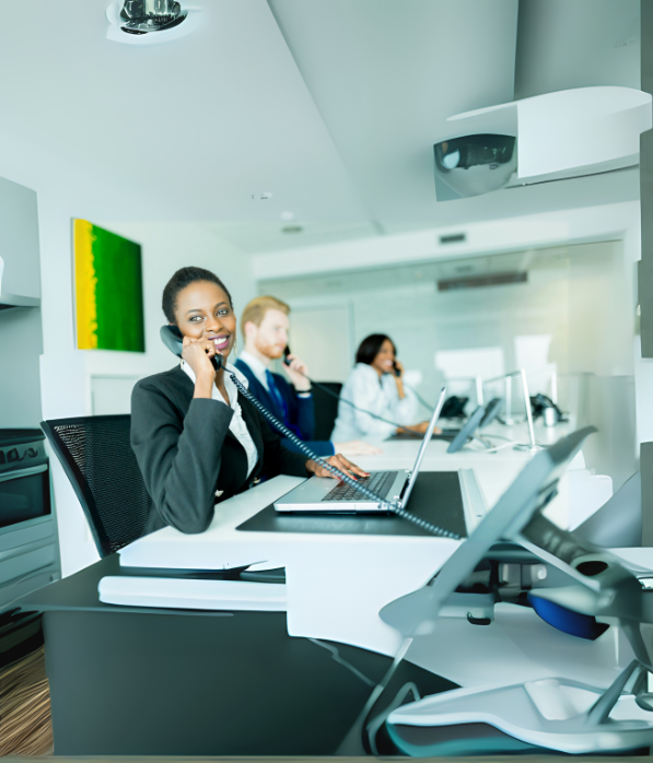 Call center with smiling reps answering calls.