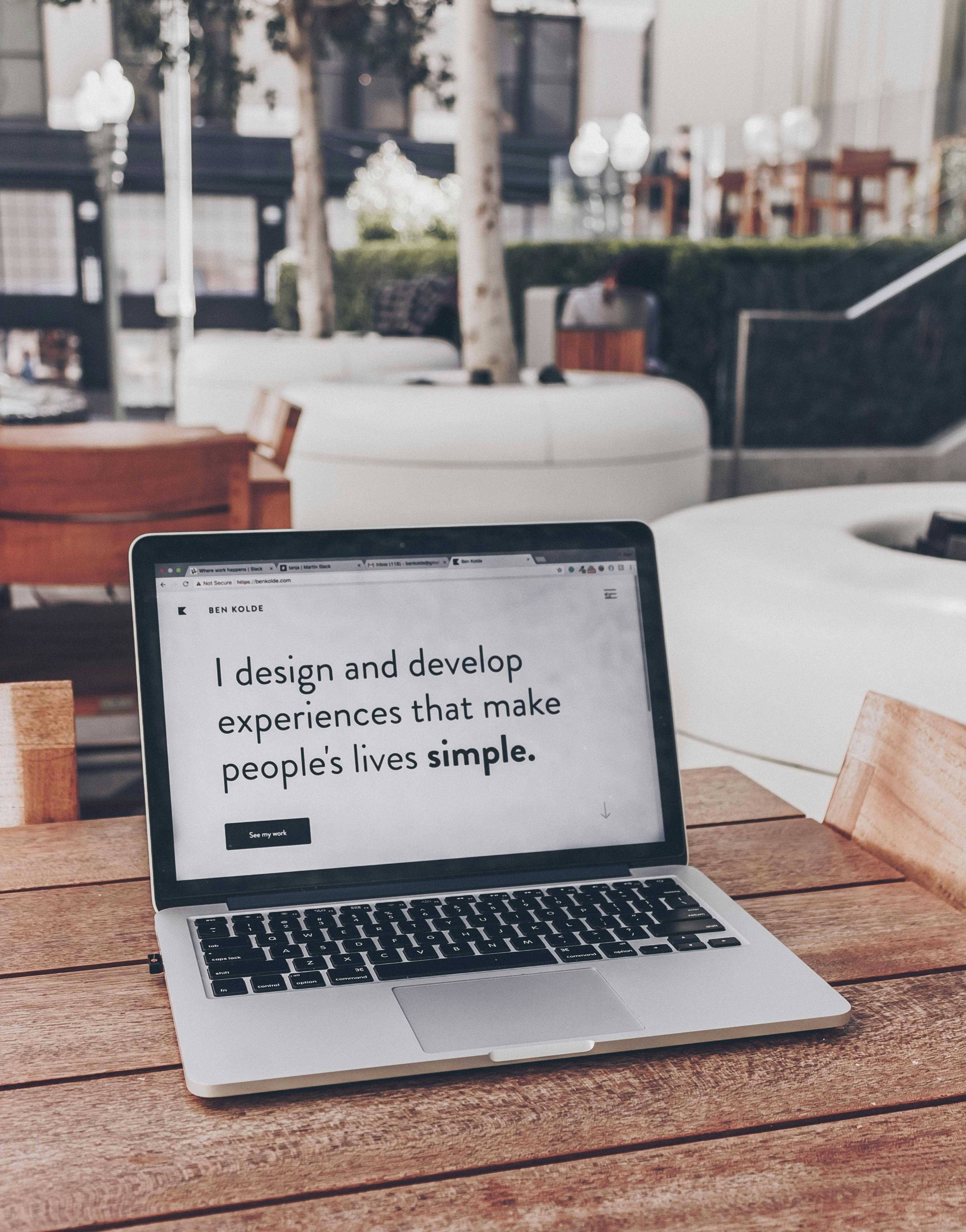 A laptop whose screen says, "I design and develop experiences that make people's lives simple."